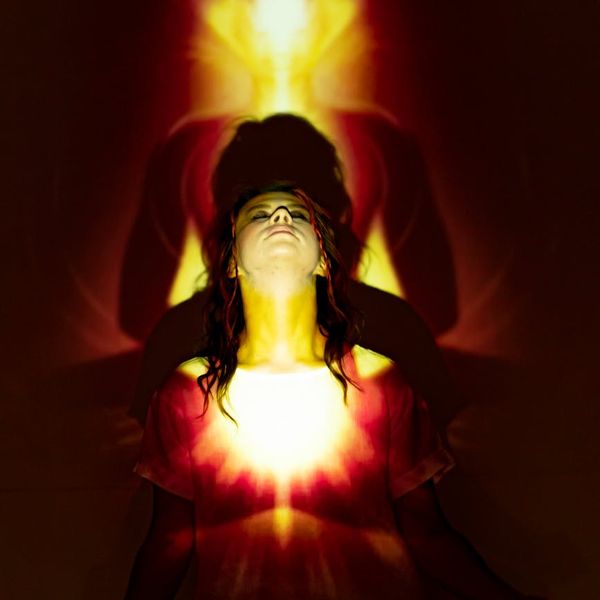 Woman in a serene yoga pose, embodying balance and focus.